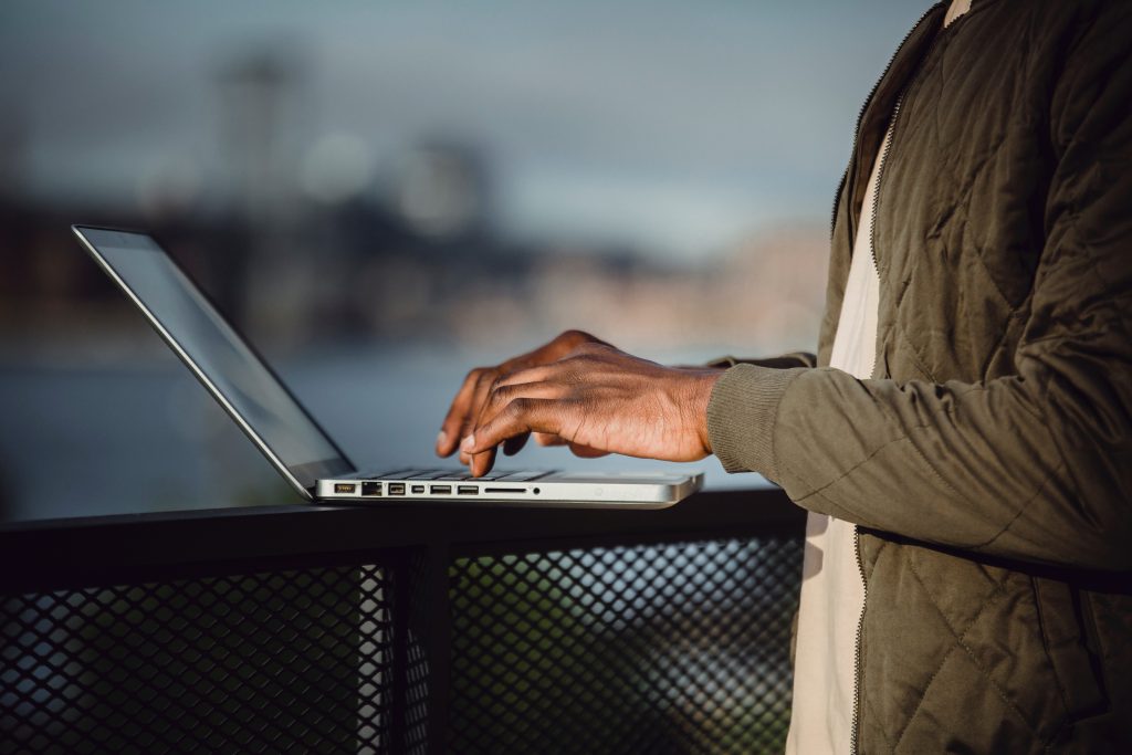 accountant working outside the office typing on a laptop