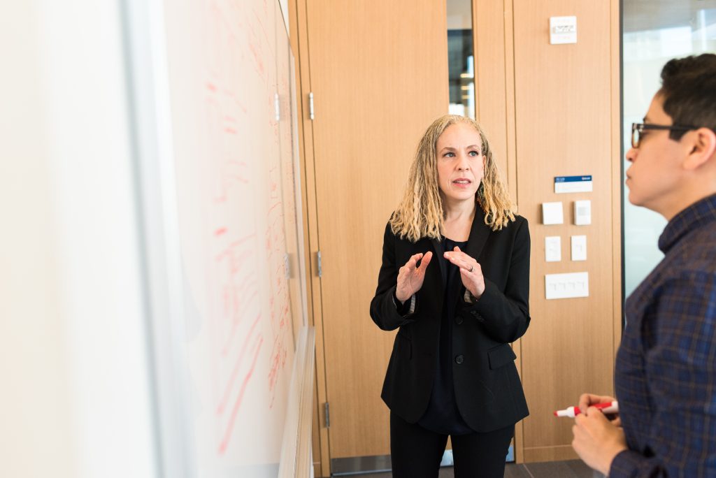 female accountant explaining report on the whiteboard