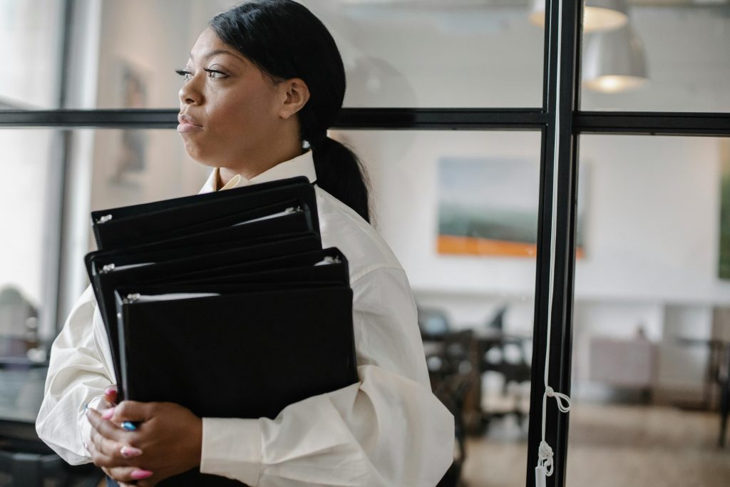 accountant holding three file folders