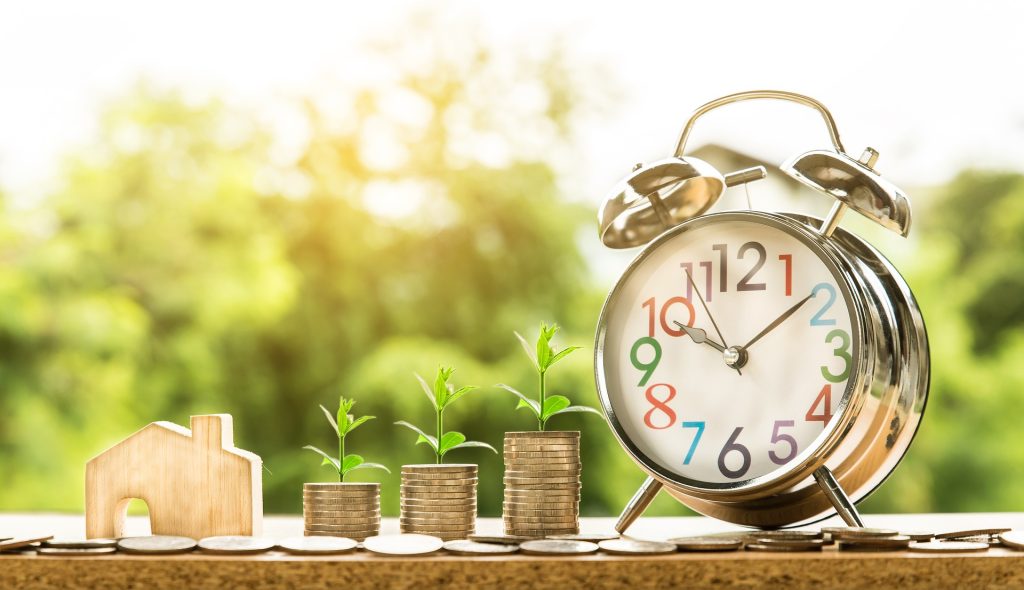 coin stacks growing beside a clock