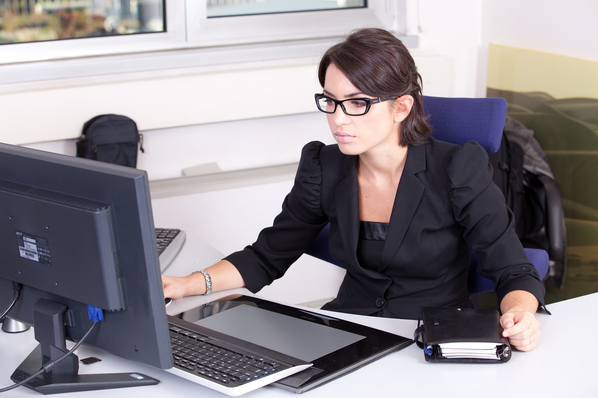 female accountant wearing black working using a laptop