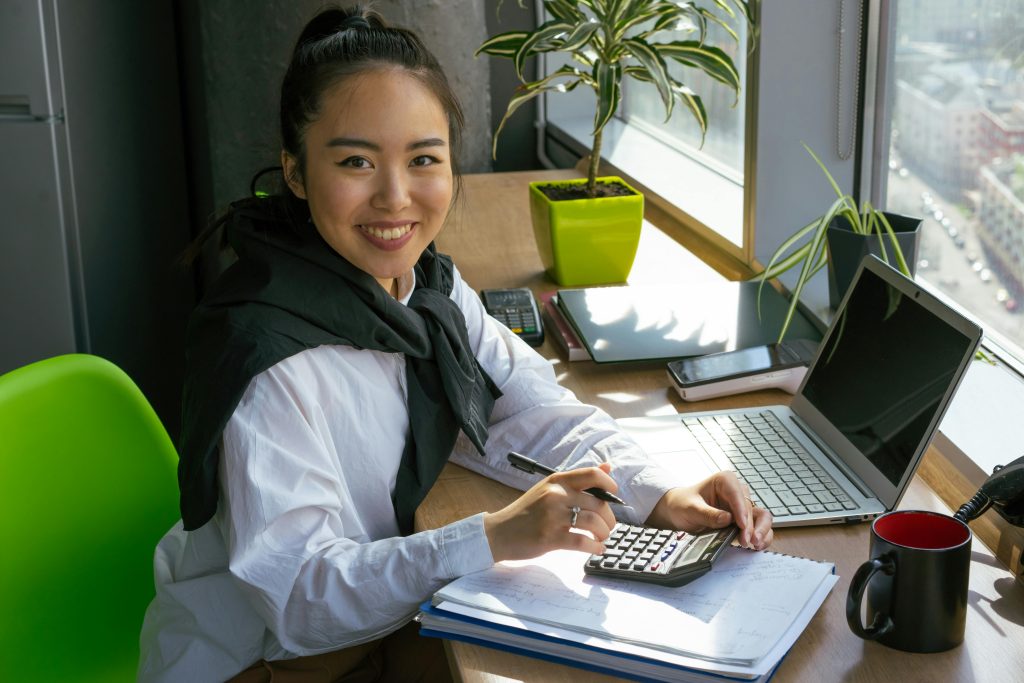 accountant smiling widely while using the calculator