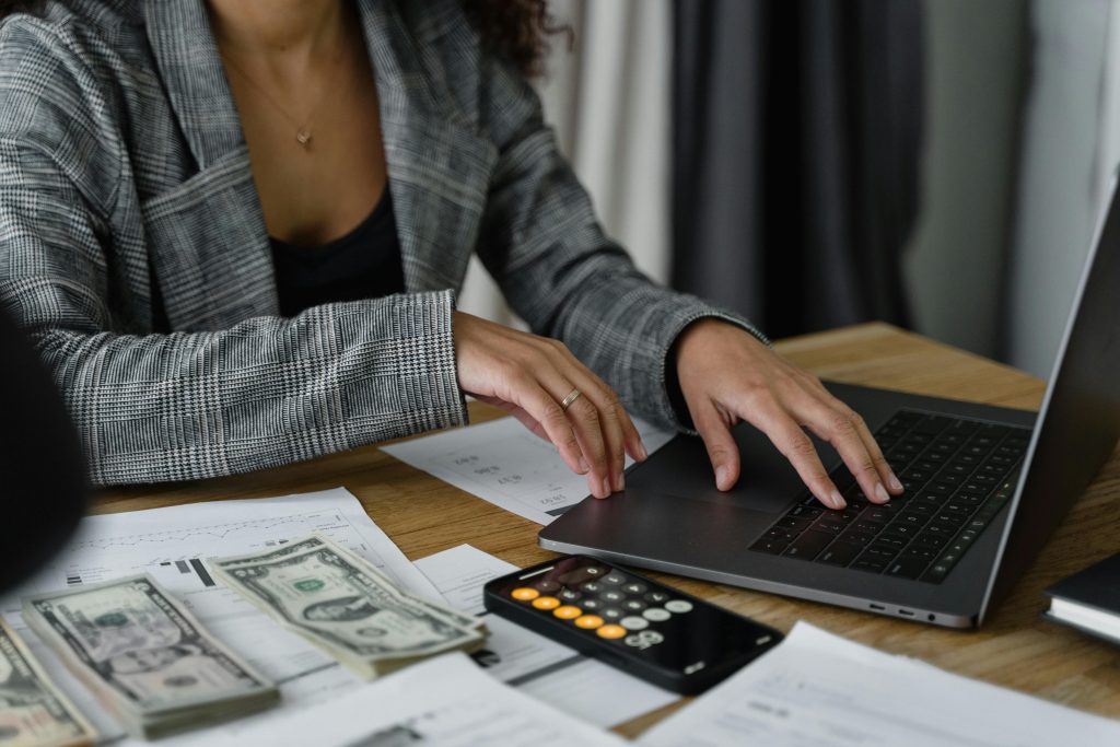 accountant using laptop and calculator to work