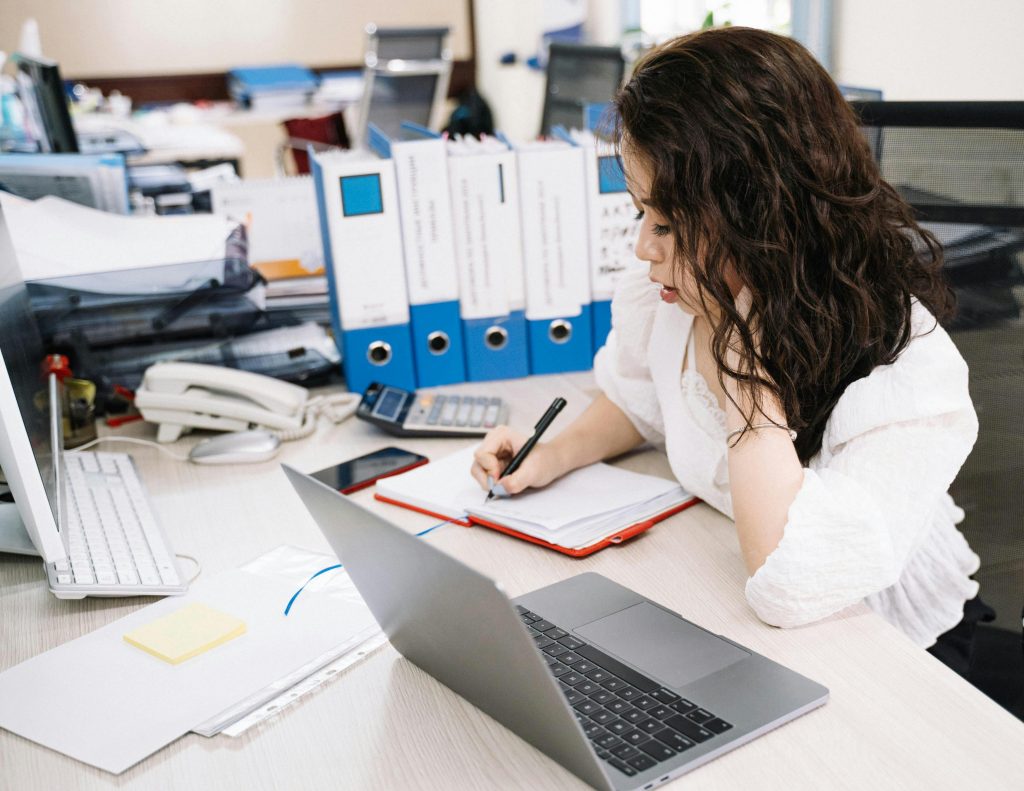 female accountant writing on her notebook