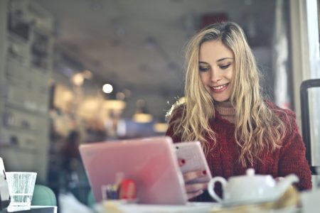 smiling accountant while using her mobile phone