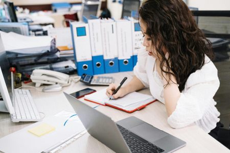 female accountant writing on her notebook