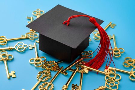 College education is the key to success, university graduation, academic opportunity and successful graduate concept with mortar board cap and many gold keys isolated on blue background