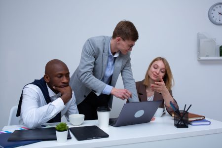 group of accountants having a meeting and checking the laptop